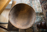 Interior view of a vintage wooden bowl showing its rich patina and textured wear.