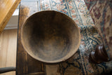 Close-up of the vintage African wooden bowl's dark, aged interior texture.