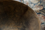 Aged interior of vintage African wooden bowl, showing wood grain and imperfections.
