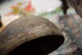 Vintage African wooden bowl with aged wood grain and textured surface.