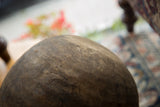Aged wood texture of vintage African bowl, with visible scratches and carved mark.