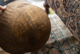 Rich, hand-carved texture and warm wood grain on the vintage African bowl.