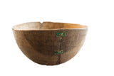 Vintage handmade African wooden bowl, aged wood with distinct green metal stitched repair.