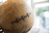 Vintage African wooden bowl close-up: rustic metal repairs and aged texture.
