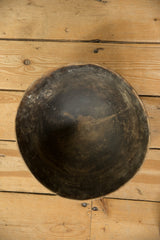 Overhead view of the vintage wooden bowl's dark, timeworn interior patina.