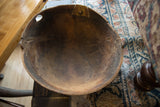 Vintage African wooden bowl interior, highlighting aged wood texture, surface imperfections, and metal repair.
