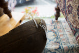 Dark aged wood of vintage African wooden bowl, with engraved metal banding and tag.