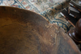 Vintage African wooden bowl interior with visible aged texture, scratches, and a crack.
