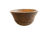 Vintage African wooden bowl with geometric carved patterns and natural brown wood tones.
