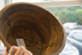 Vintage African wooden bowl interior detail, highlighting rich brown wood grain and aged imperfections.