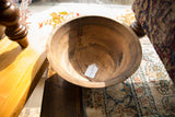 Interior of vintage African wooden bowl with SKU tag, showing cracks and staple repair.