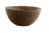 Vintage handmade African wooden bowl with a dark, weathered patina and rustic character.