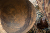 The rustic, textured interior of a vintage African bowl showing a rich, lived-with patina.