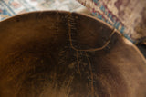 Detail view of the rustic, wavy staple repair inside the African wooden bowl.