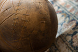 Close-up of the vintage Tuareg wooden bowl showing traditional metal staple repairs and aged texture.