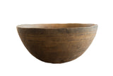 Vintage handmade African wooden bowl with a dark patina and carved decorative bands.