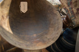 Close-up of the dark, textured interior of a vintage wooden bowl, showing age cracks.
