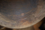 Aged wood grain and character-rich cracks on the dark interior of the vintage bowl.