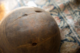 Historic cracks and aged texture on a handmade African wooden bowl.