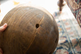 Vintage African wooden bowl showing aged character with a visible crack and small hole.