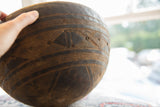 Close view of the hand-carved geometric line work on the dark vintage wooden bowl.