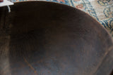 Aged character and texture on the dark, hand-carved interior of the vintage bowl.