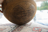 Hand-carved geometric patterns and natural dark patina on a vintage African wooden bowl.
