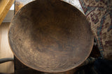 Detail of vintage African wooden bowl's dark interior with rich patina and textural cracks.