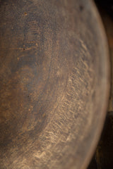 Aged dark brown wood texture inside vintage African bowl, showing wear and grain.