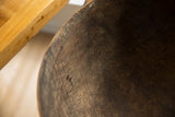 Vintage African wooden bowl's dark, aged wood texture with visible imperfections.