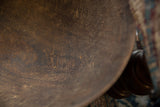 Brown wooden bowl interior showing aged texture, visible wood grain, and small imperfections.