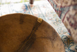 Historic metal staple repairs and aged patina on a vintage Tuareg wooden bowl.
