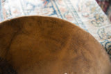 Aged patina and character marks on the interior surface of the vintage wooden bowl.
