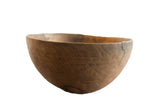 Vintage African wooden bowl with a rustic, hand-carved texture and an aged wood patina.