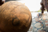 Close-up of the warm-toned wood and hand-tooled texture of a vintage bowl.