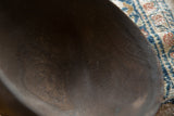 Textured dark wood interior of the vintage African bowl, showcasing natural grain.