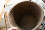Dark aged wood interior of the vintage African bowl, revealing natural cracks and texture.