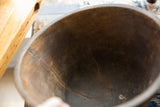 Close view of the dark, aged interior of the vintage African wooden bowl, highlighting cracks.