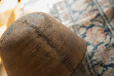 Close-up of vintage African wooden bowl showing carved patterns and a prominent crack repair.