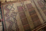 Close view of vintage African Tuareg mat, highlighting handwoven straw texture and geometric pattern.