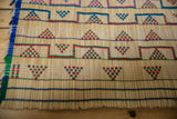 Detail of the handwoven straw and colorful geometric patterns on a vintage Tuareg mat.