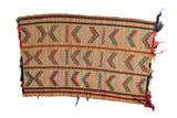 Vintage African Tuareg rug mat featuring handwoven rows of colorful geometric patterns on natural straw.