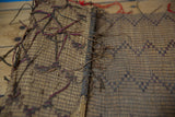 Vintage African Tuareg mat: handwoven straw texture, dark bindings, and a geometric motif.