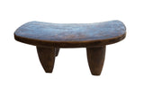 Hand-carved vintage Senufo wood stool with a dark, aged patina and three thick tapered legs.