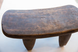 Rich wood grain and hand-carved texture of the vintage Senufo milk stool.