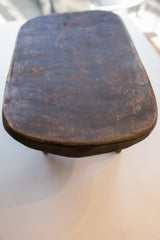 Vintage African Senufo wood stool top with dark, textured patina.