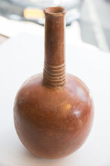 Textured rings around the neck of an antique North African red slip ware vase.