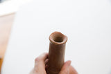 A view into the mouth of the antique red slip ware vase showing its handmade, rustic rim.