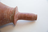 The flanged collar and ribbed opening of an antique handmade North African vase.