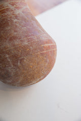 Fine horizontal lines and an earthen patina on the antique red slip ware vase.